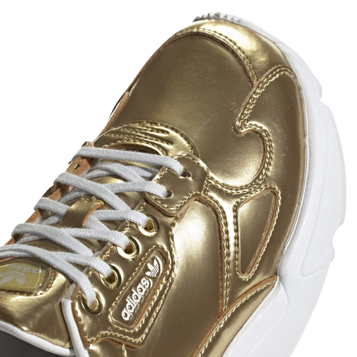 Confident '90s vibes inspire these throwback shoes. They shine bright with an eye-catching metallic synthetic upper. A contrast "X" on the outsole marks the Torsion System, a Falcon signature.